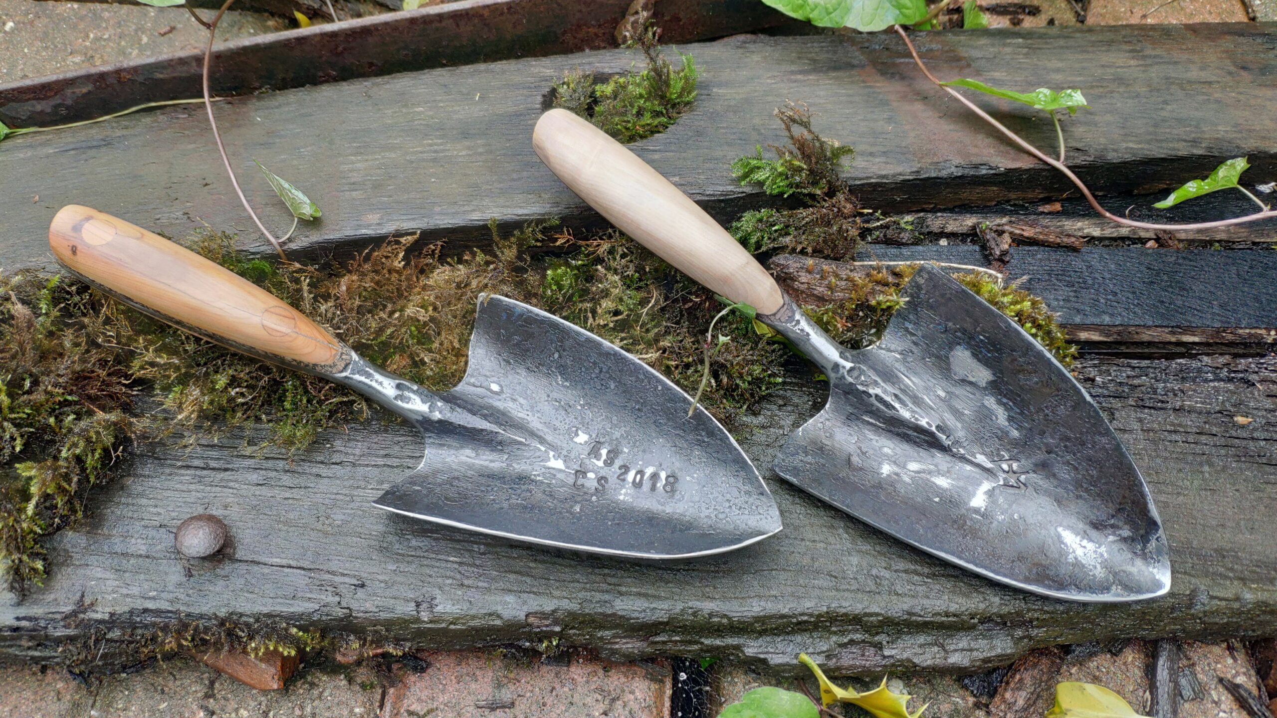 professional hand forged garden trowel with oak handle (left) and ash handle (right)